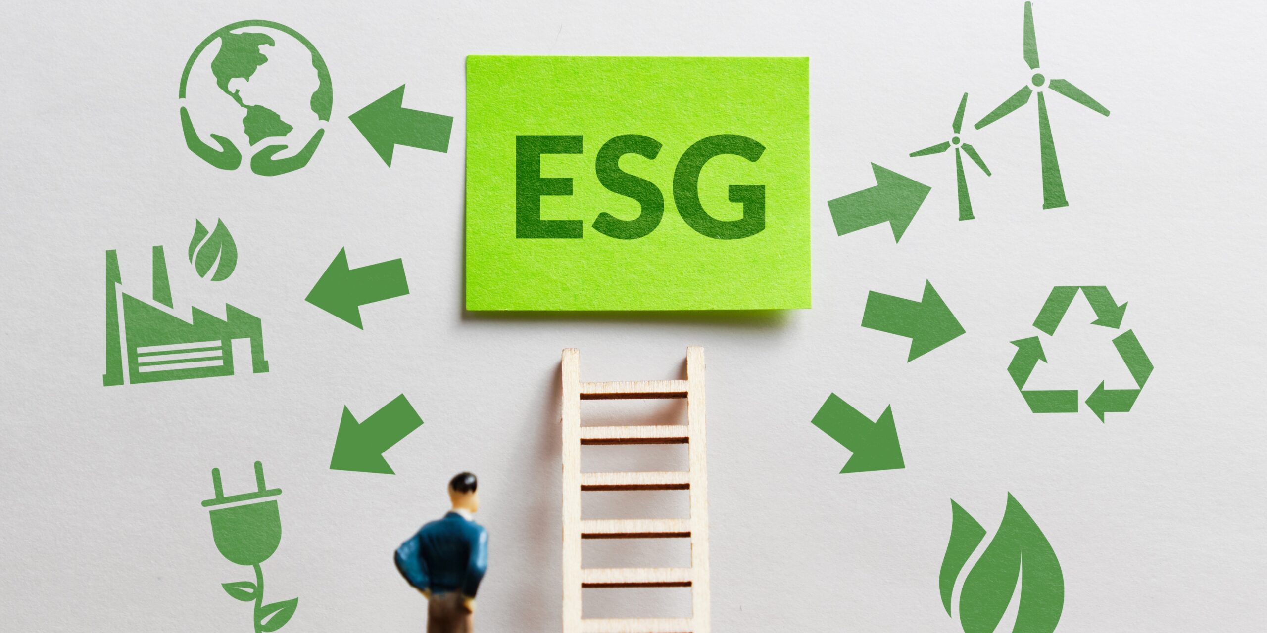 A green square with the letters 'ESG' written. Around the green square are symbols of the earth, recycling and the environment. There is a plastic ladder and person standing underneath the green square.